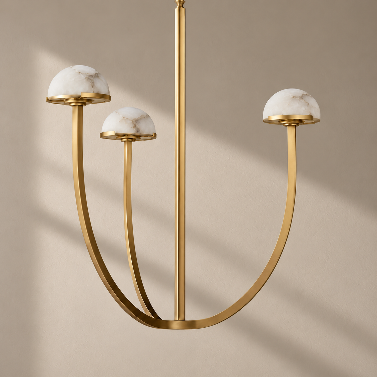 Three-light brass 3 Arch chandelier with natural alabaster domes, unlit.