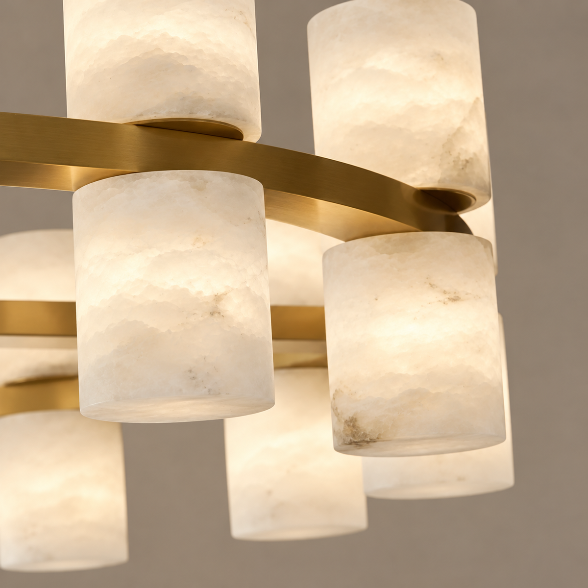 Close-up of cloudy alabaster cylinders and their brass supports.