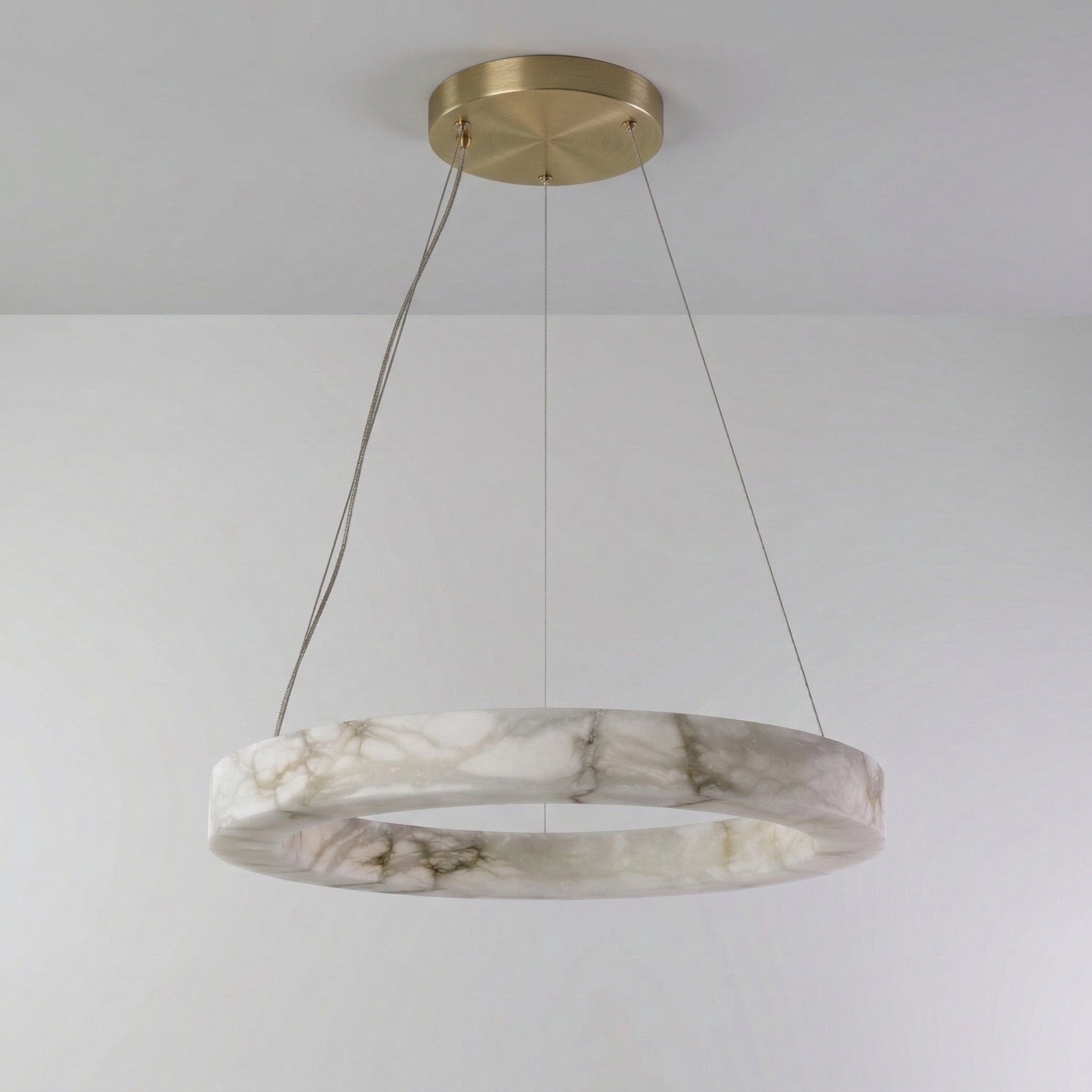 Round alabaster ring chandelier over a dining table