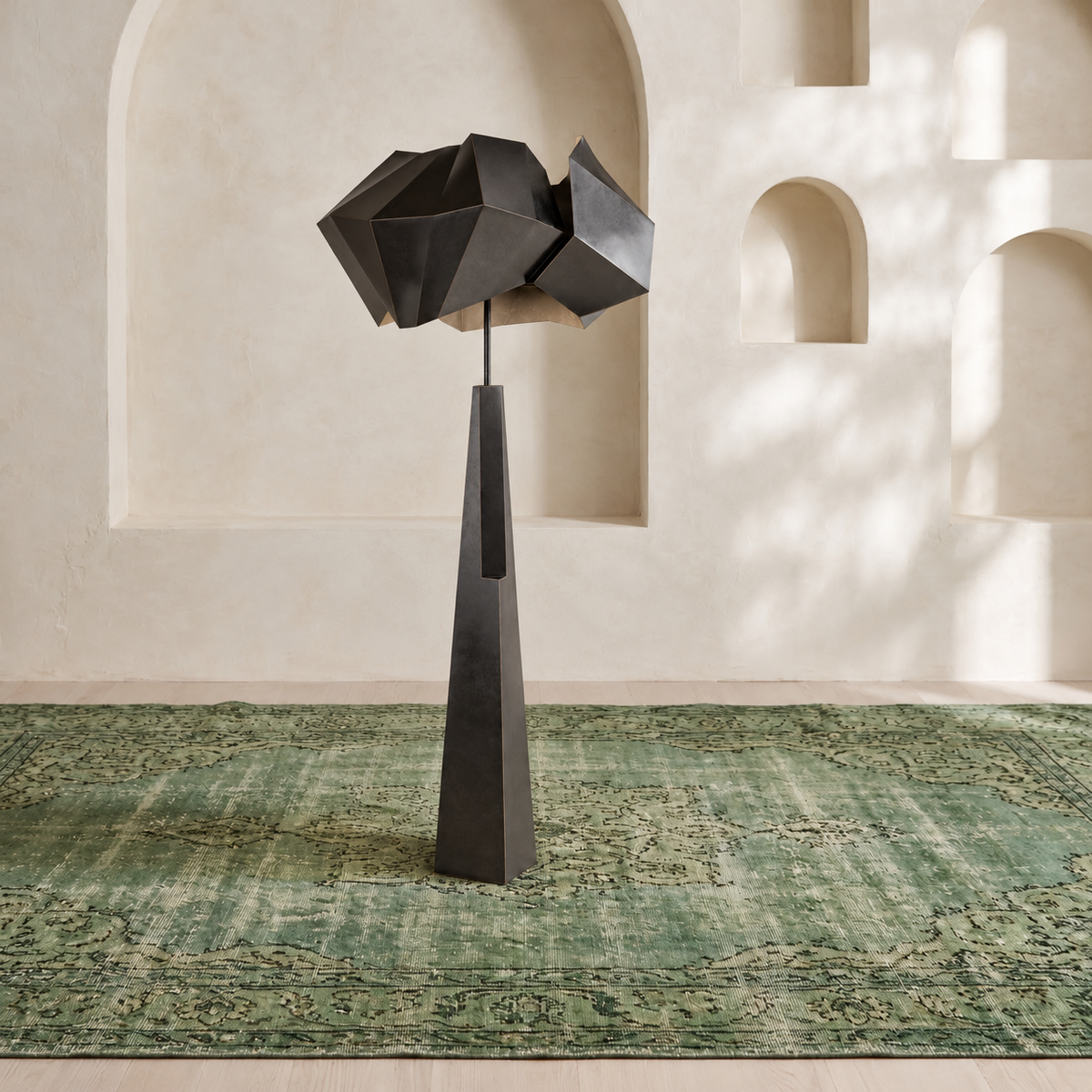 Black Aventine floor lamp on a green rug in a room with sculptural plaster niches
