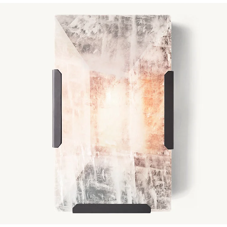Hand-cut calcite in a matte-black copper frame glowing warm