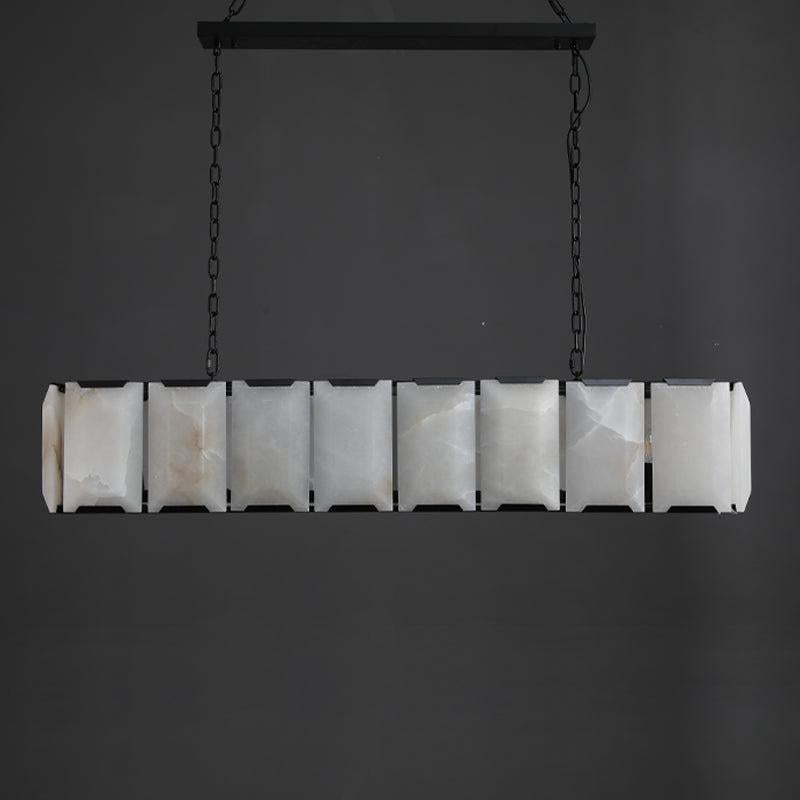 Staggered top edge of alabaster panels in a black steel cage
