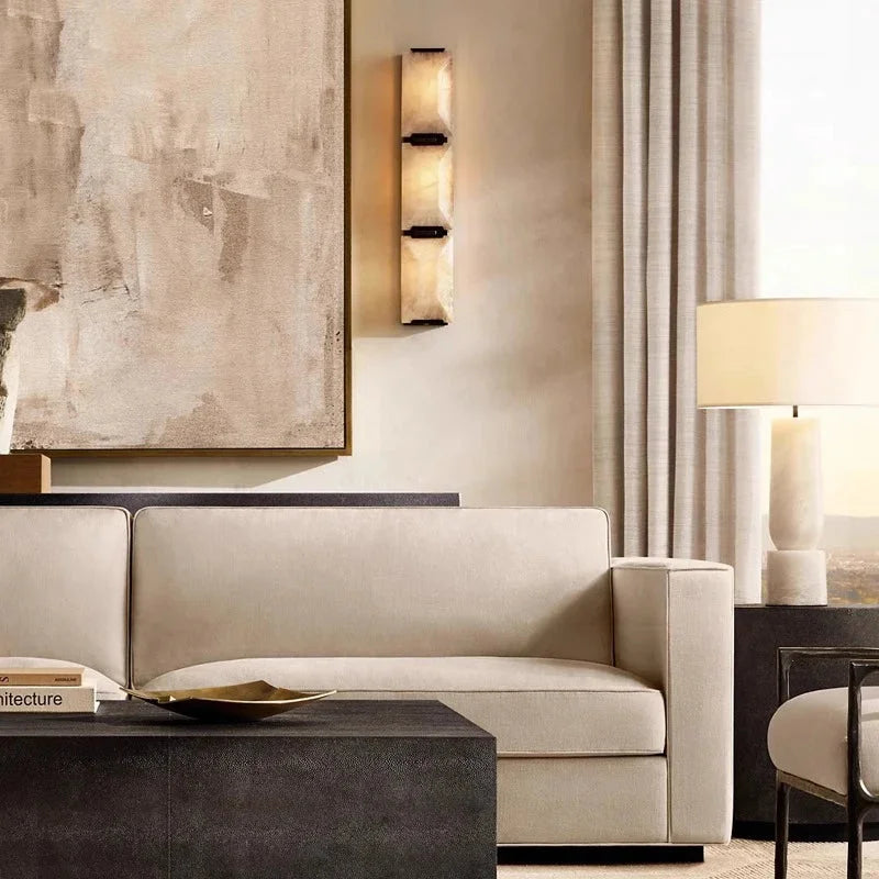 Three stacked calcite slabs in a matte-black copper frame glowing warm