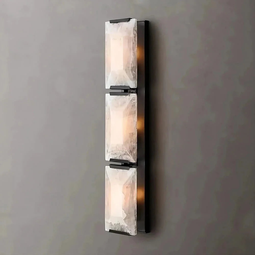 Black triple calcite and copper wall sconce on a staircase
