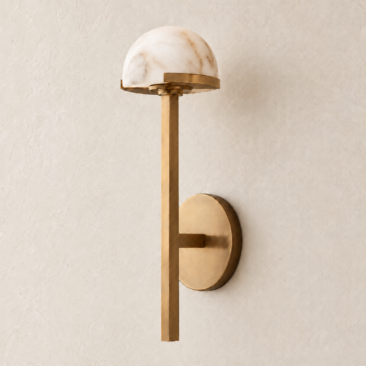 Oblique view of the compact brass and alabaster dome sconce, showing the round wall plate.