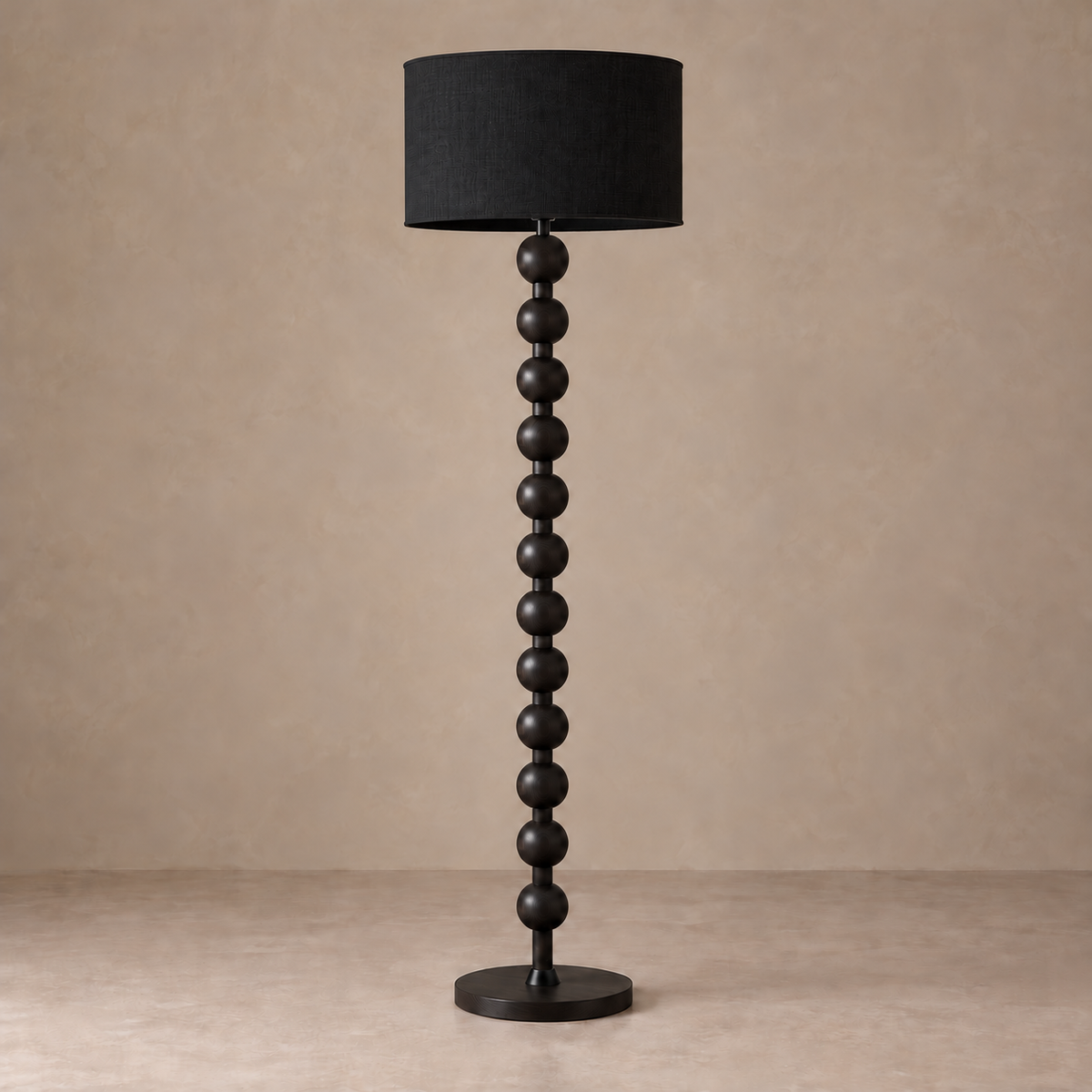 Black CL40XZ8 floor lamp with a beaded column, black drum shade and round base.