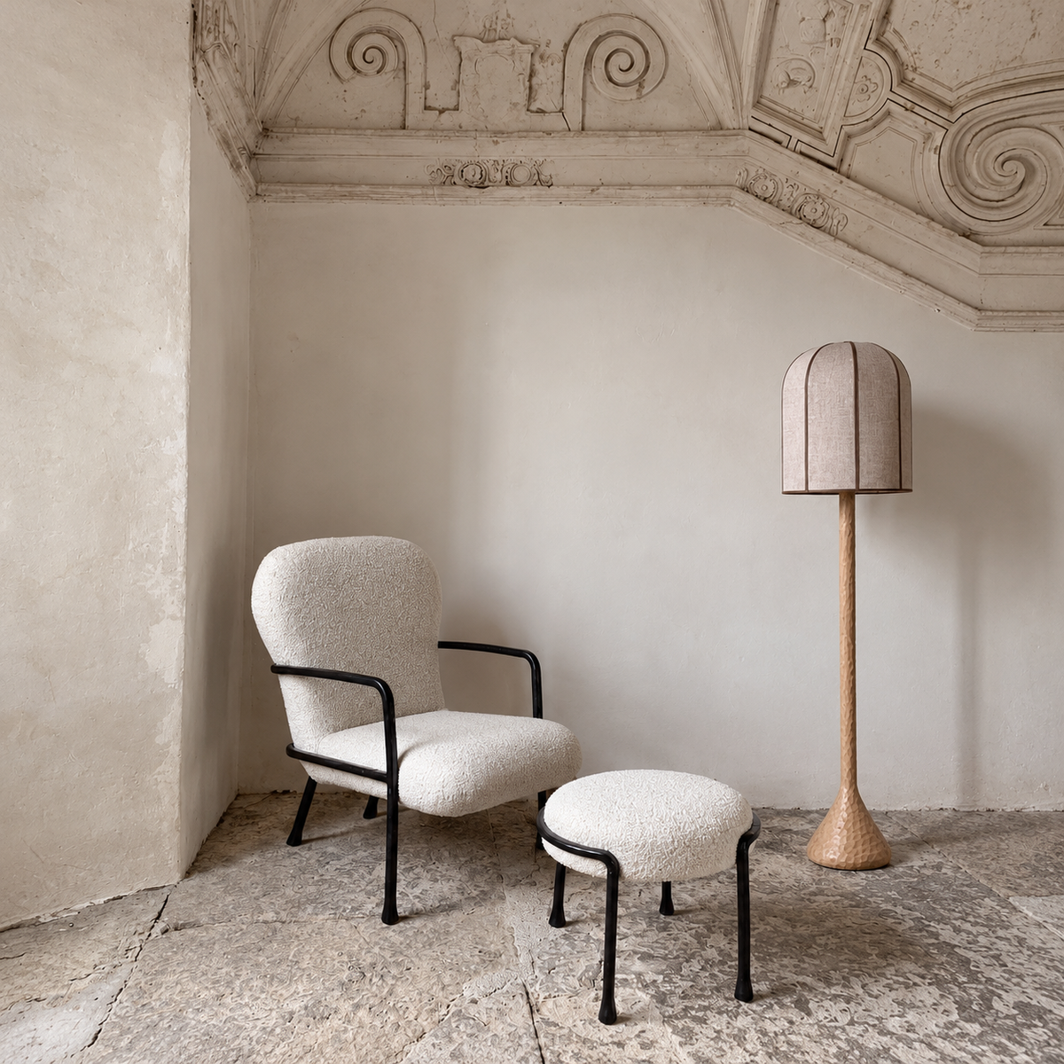 CL70ZZ Bell floor lamp beside a boucle chair and ottoman in a stone alcove with an ornate ceiling.