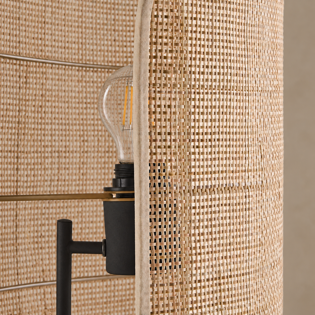 Close view of the wicker weave, bound shade edge and black bulb holder.
