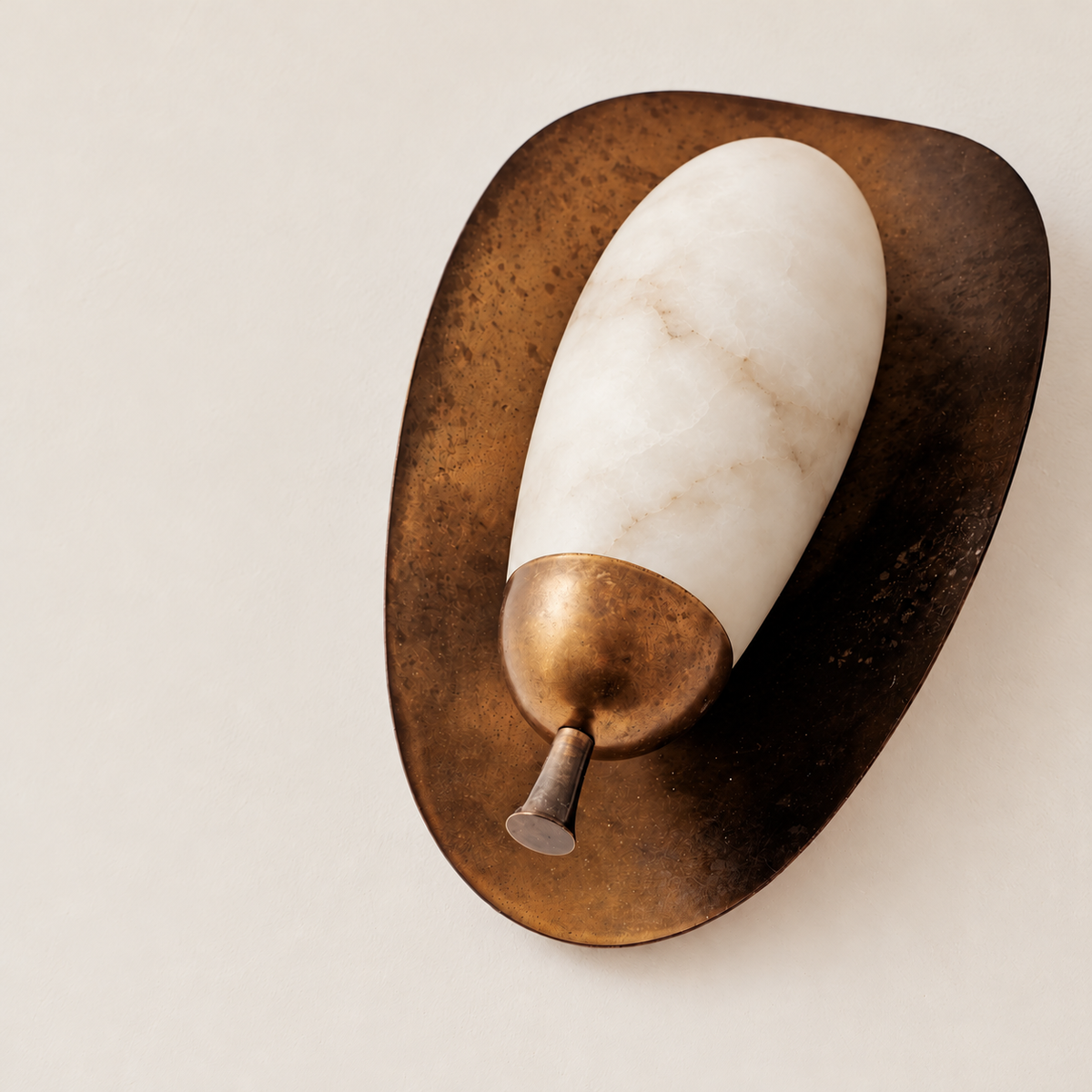 Lower angled view of the CLASYH87 alabaster shade, brass cup and finial on beige.