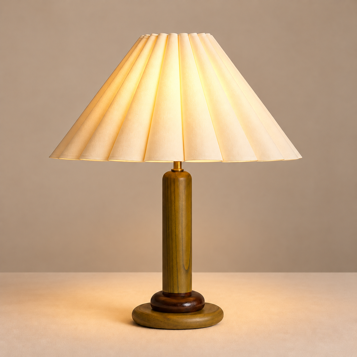 Olive wood table lamp with its pleated shade illuminated