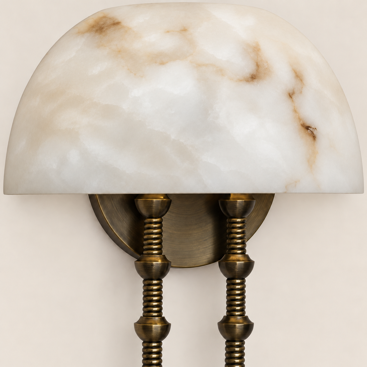 Close-up of the veined alabaster dome and segmented brass stems.