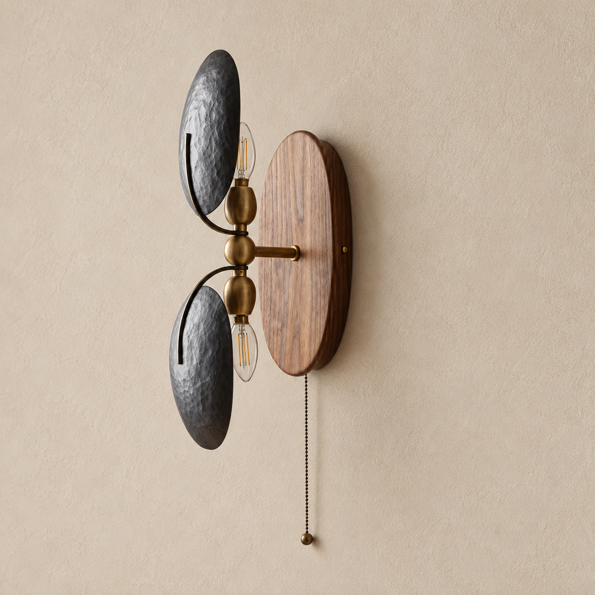 Side view of the walnut and iron wall sconce, showing the brass arm, two lamp holders and pull-chain switch.