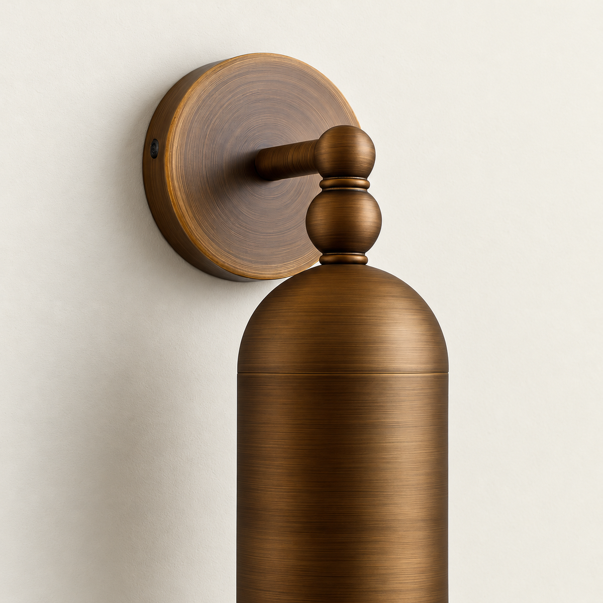 Close-up of the brushed brass backplate, twin ball joints and domed tube cap.