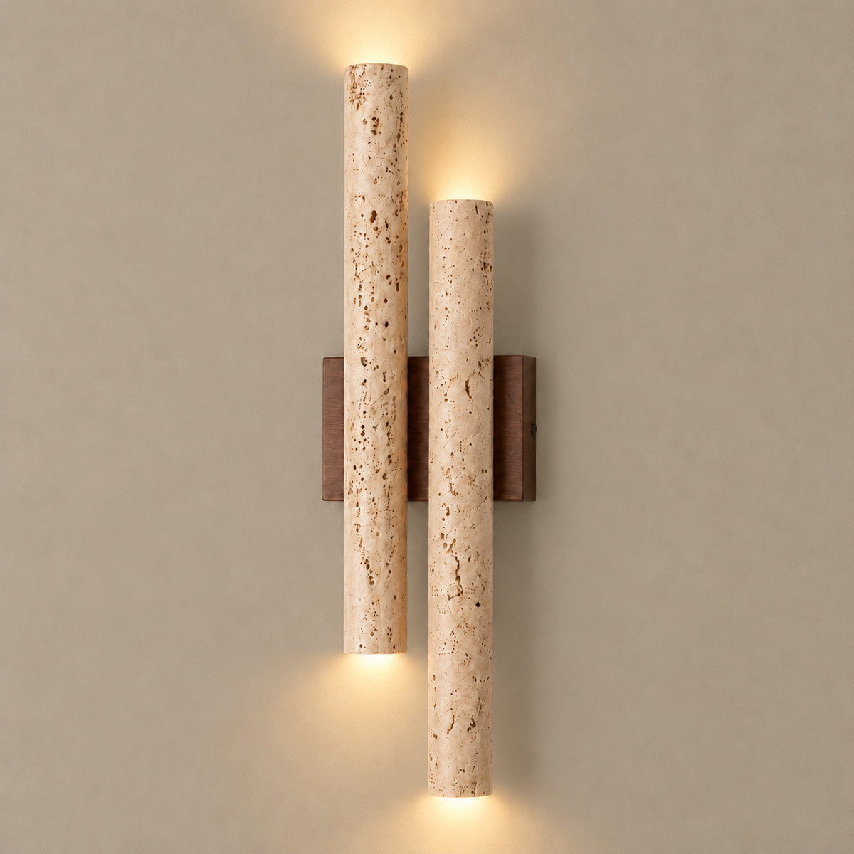 Double travertine and walnut wall sconce, illuminated on a stone-beige wall