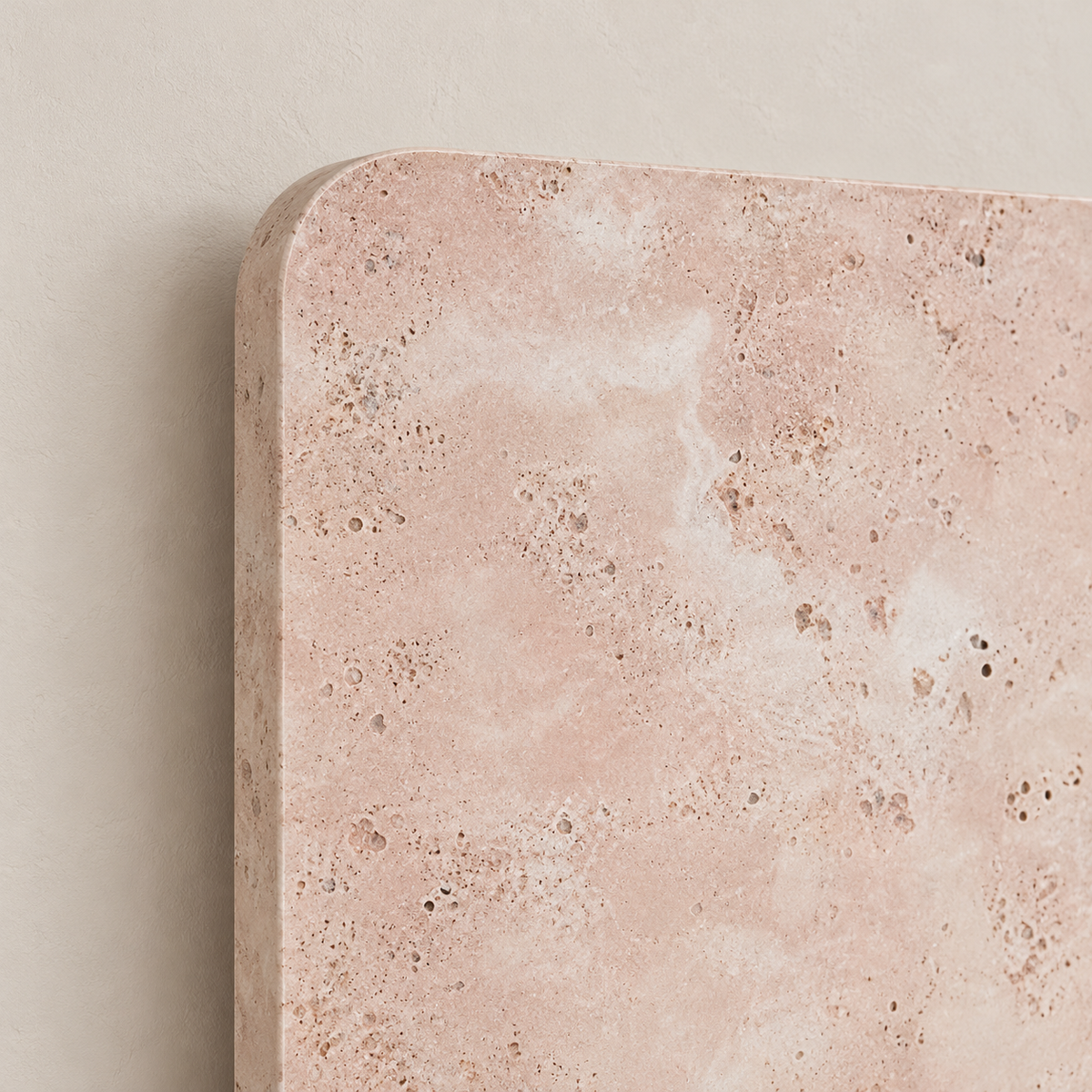 Close-up of the pink marble wall lamp’s natural mineral pattern and rounded corner.