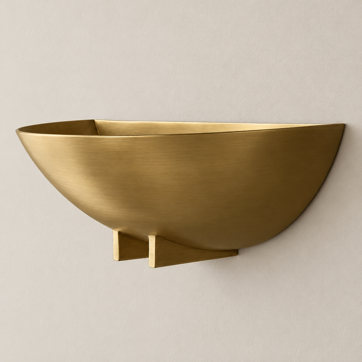 Brass bowl wall sconce, switched off on a beige wall.