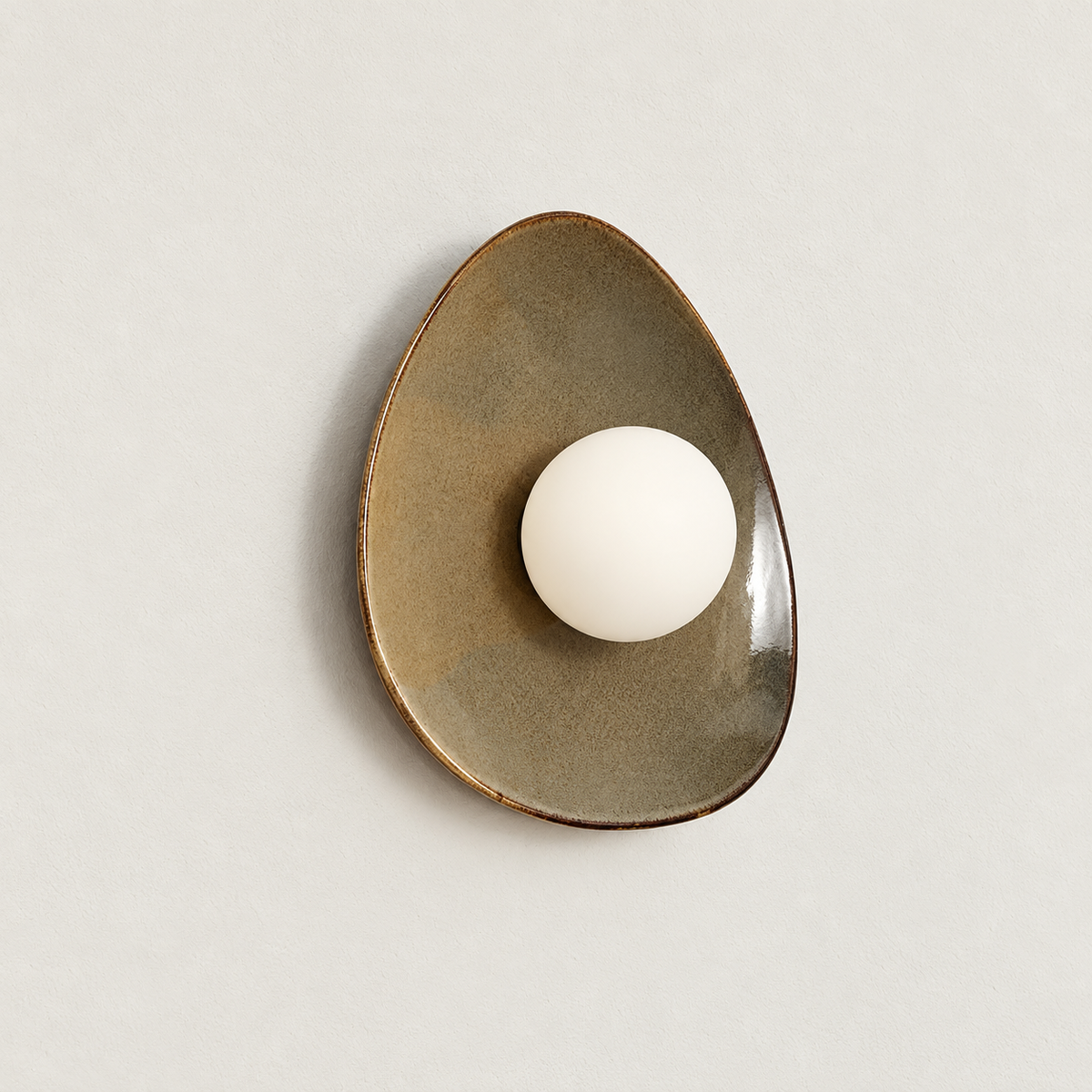 Angled view of the glazed ceramic dish and projecting glass globe.