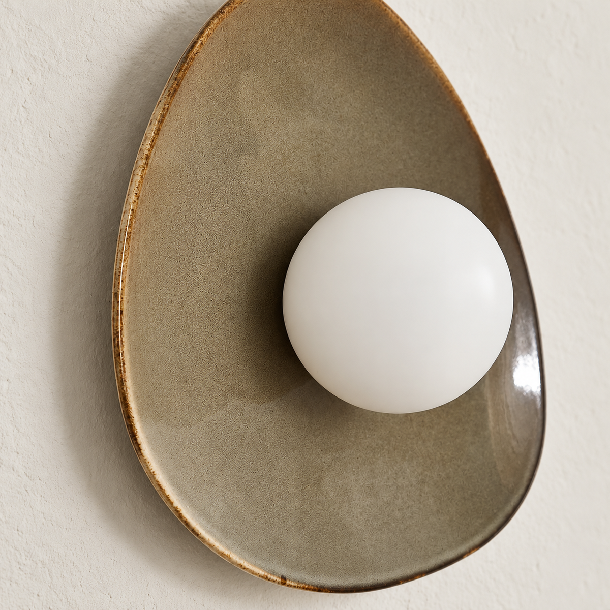 Close-up of the ceramic glaze, curved rim and opal glass globe.