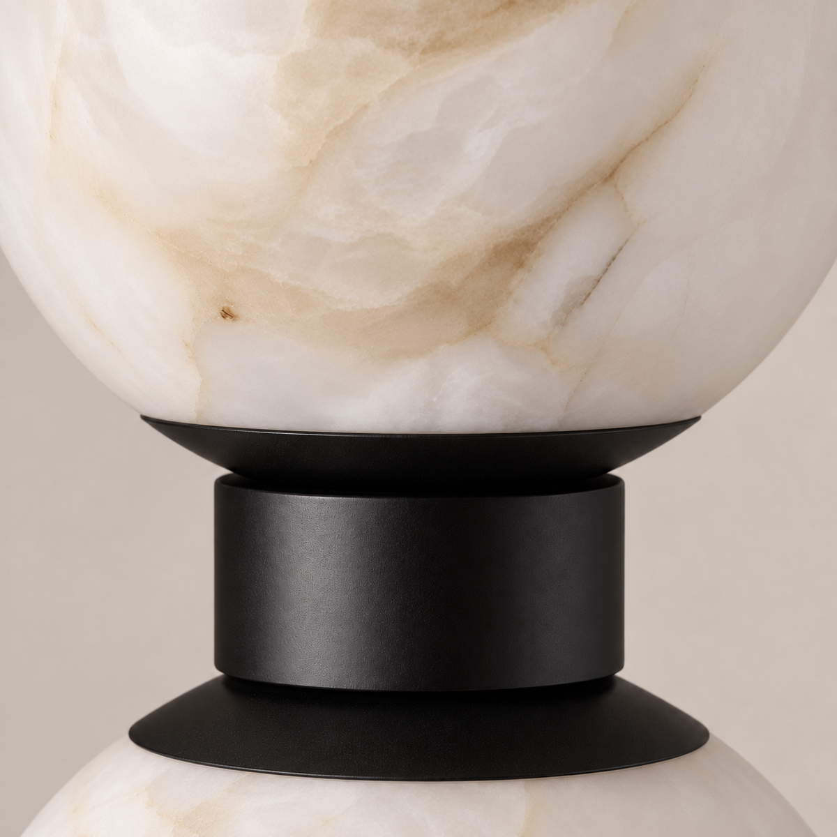 Close-up of natural alabaster veining and the black central collar between the globes.