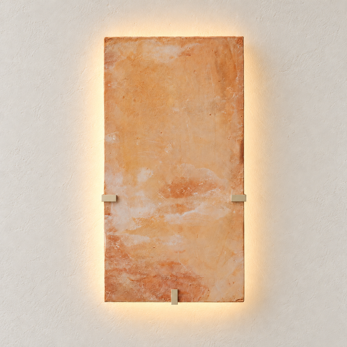 Parefeuille Petite terracotta wall sconce illuminated with a soft halo behind the clay slab.