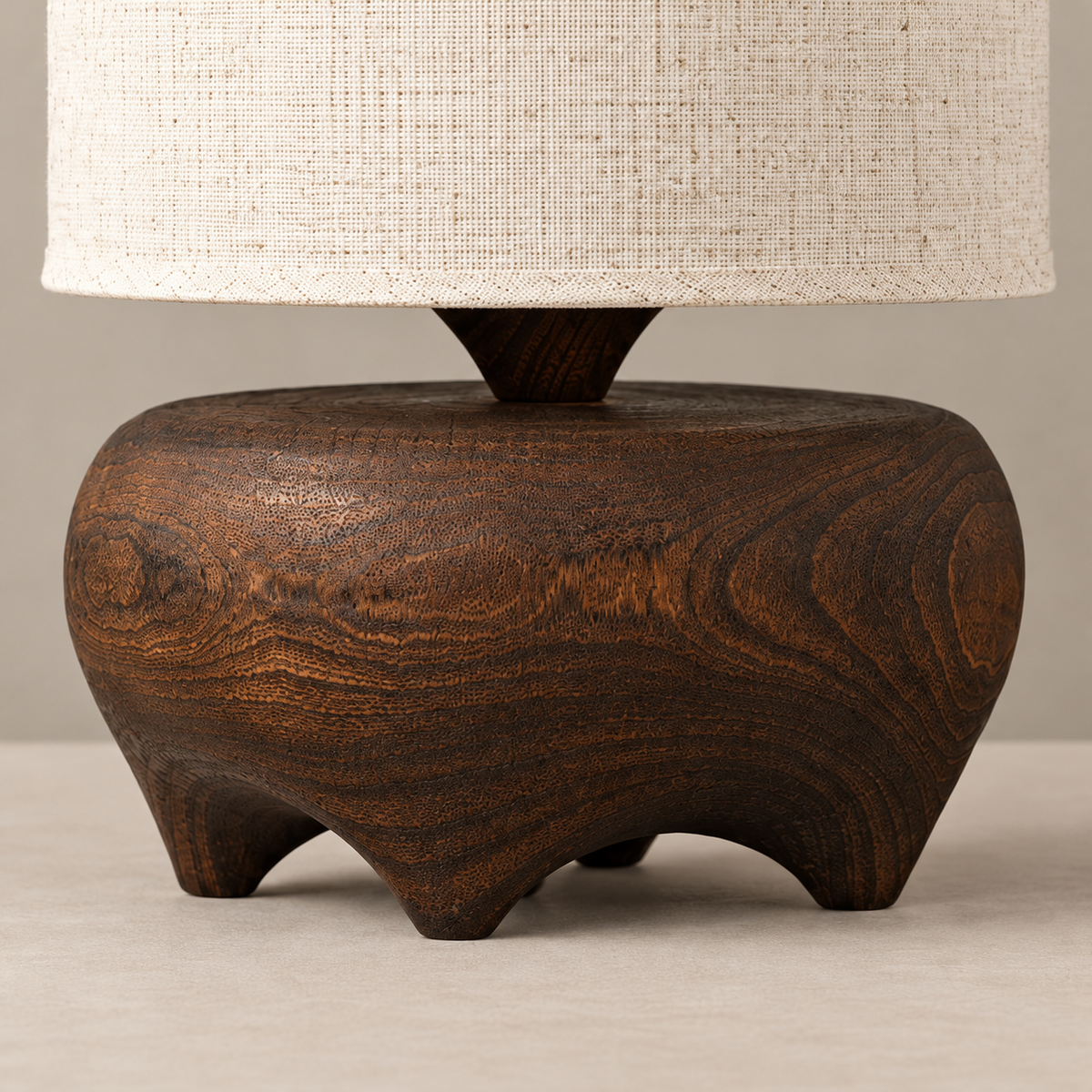 Close-up of the carved wood grain, feet and linen shade