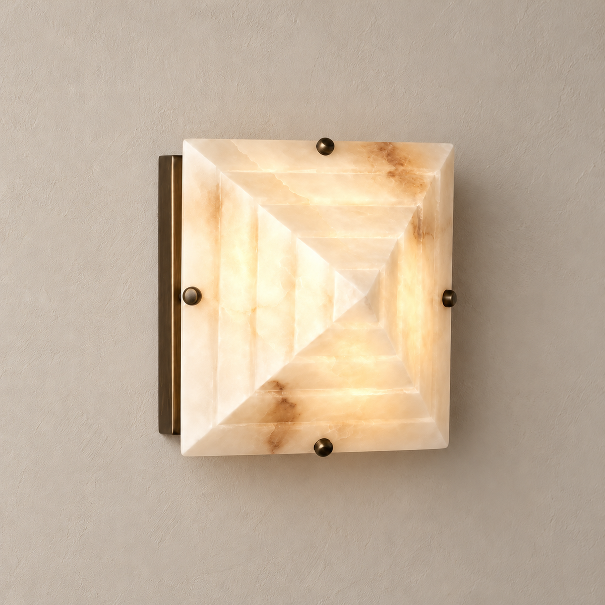 Square alabaster sconce illuminated through its natural mineral layers.