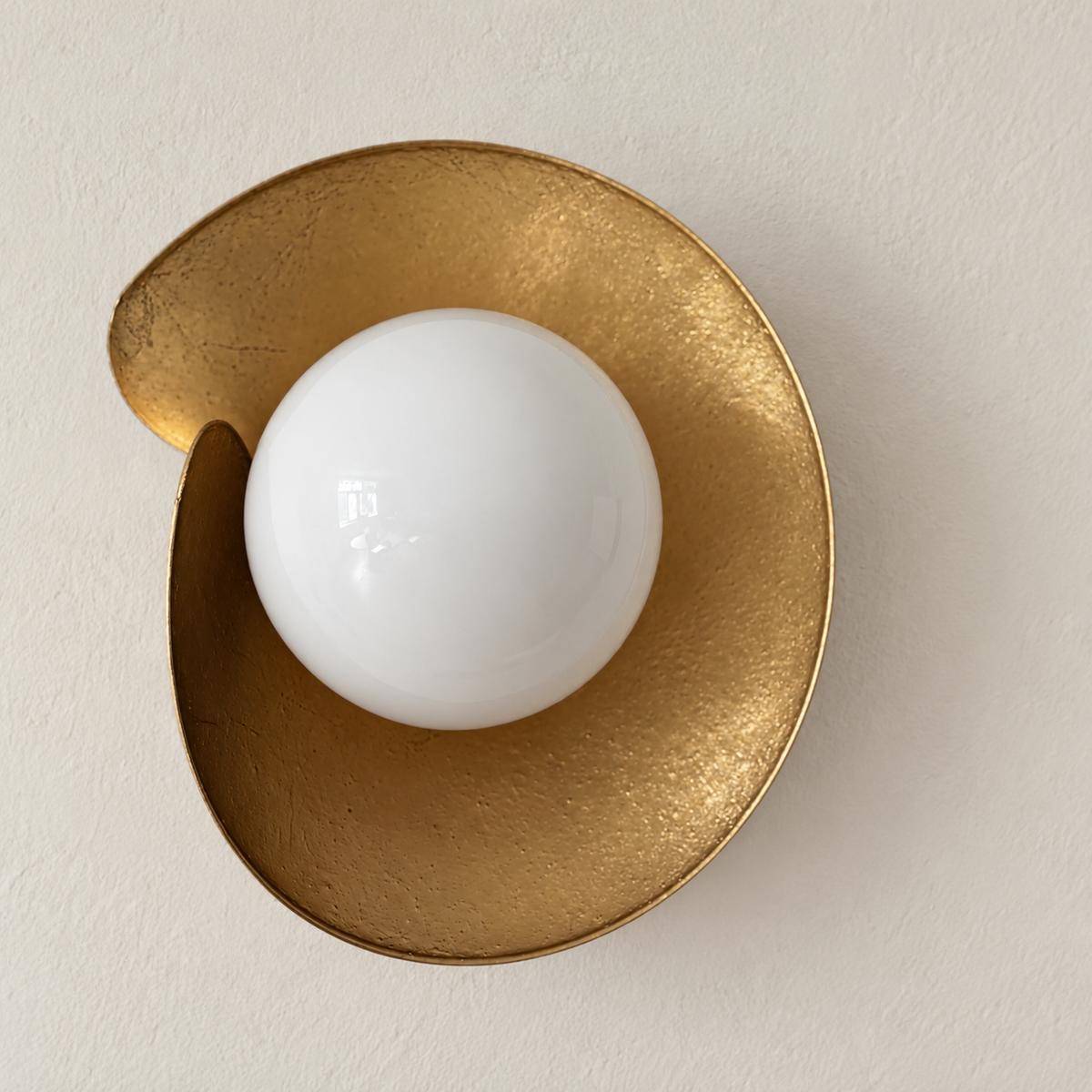 Angled view of the folded copper shield and white glass globe.