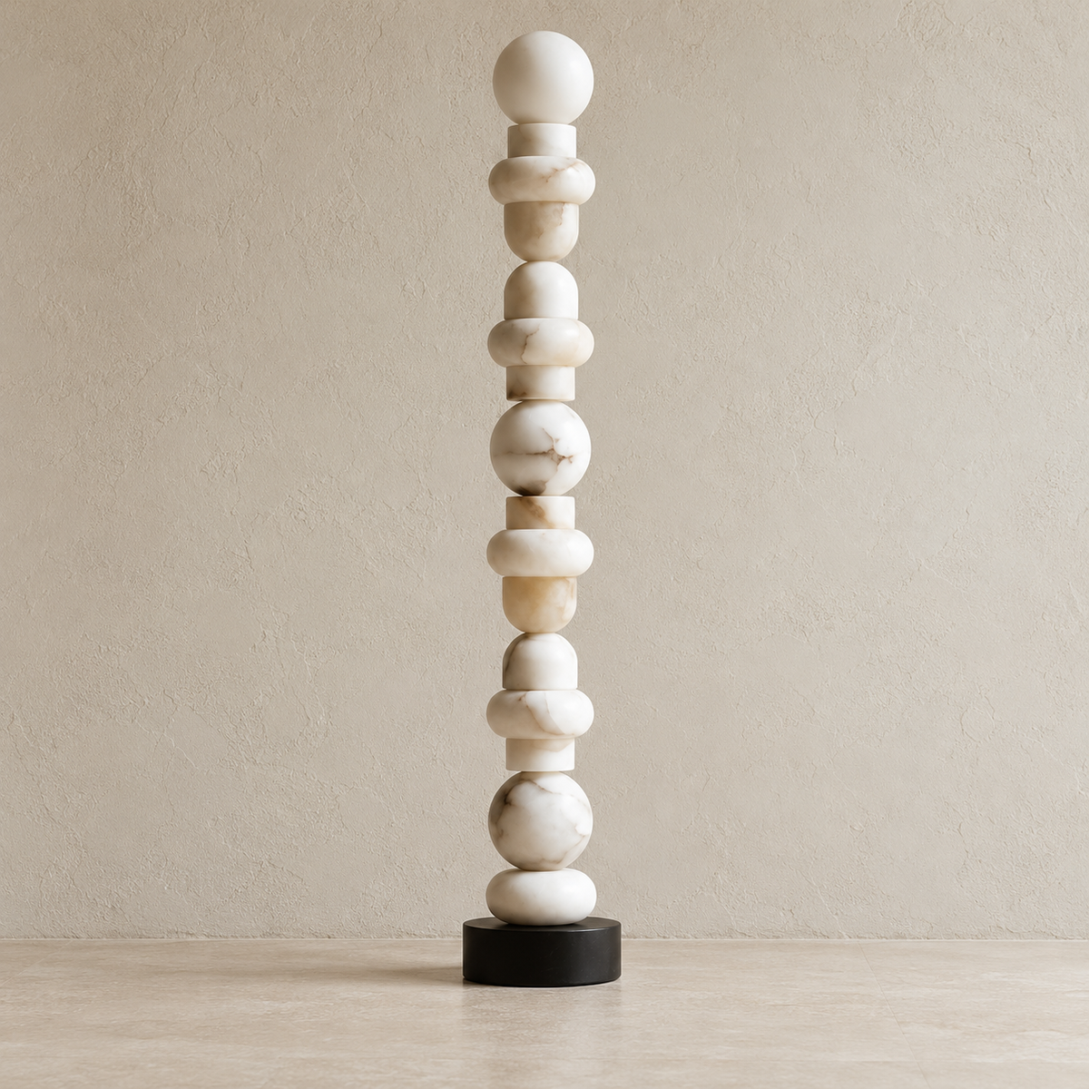 Angled view of the Grenaldi lamp's stacked alabaster forms and black marble base.