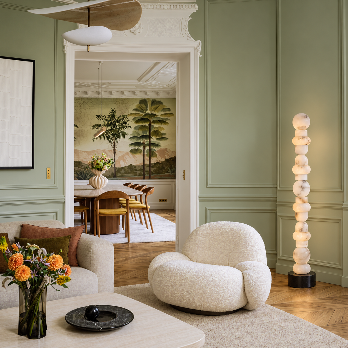 Grenaldi alabaster floor lamp beside a boucle chair in a daylit sage-green living room.