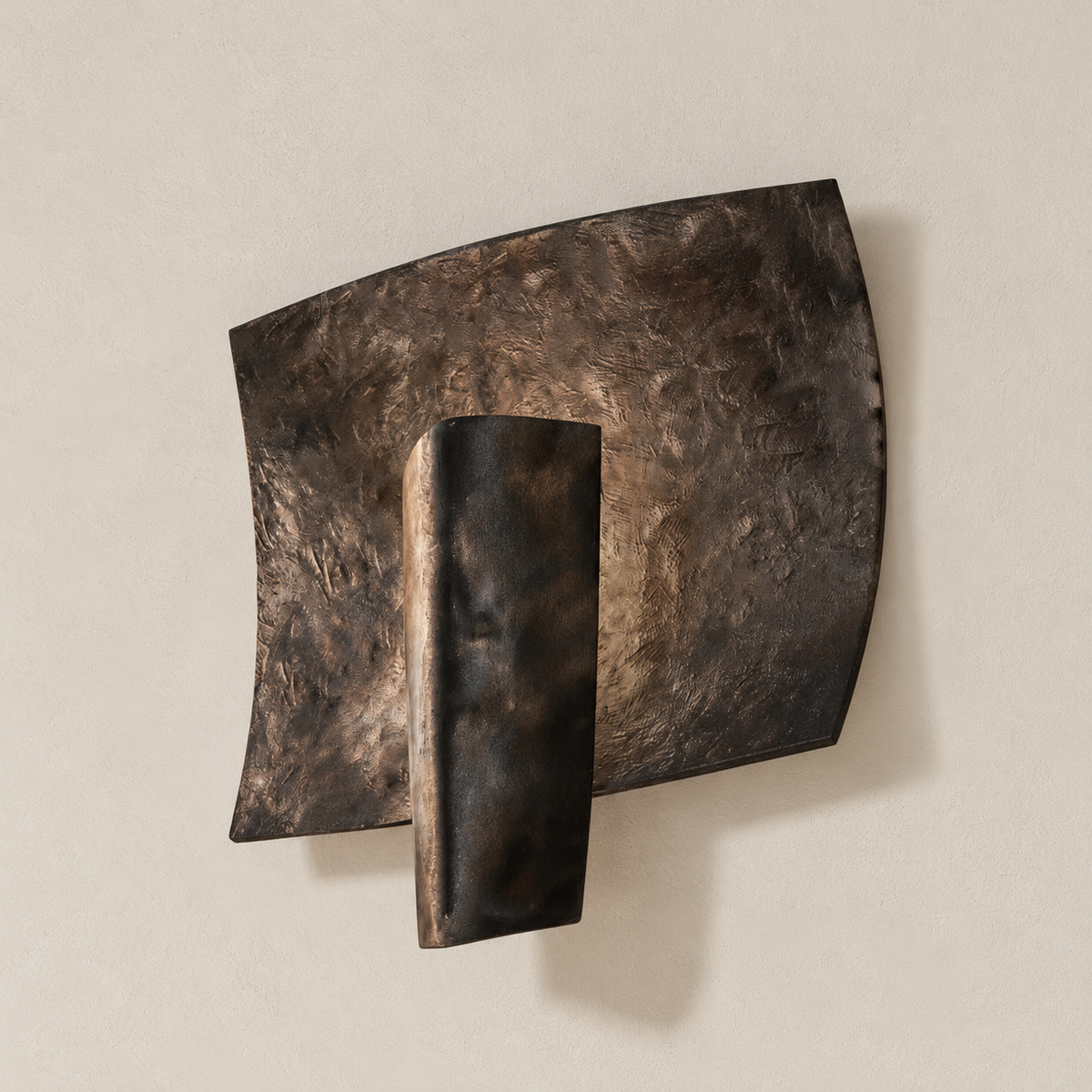 Angled view of the curved hammered panel and tapered shield on the Kyrin sconce.