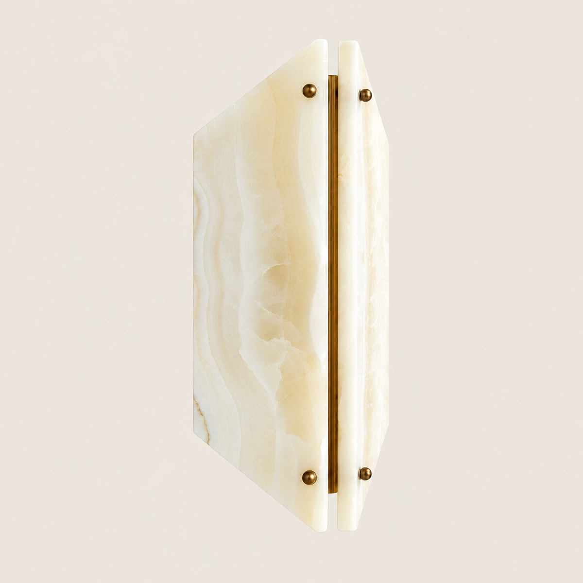 Angled view of two onyx panels and the central brass spine.