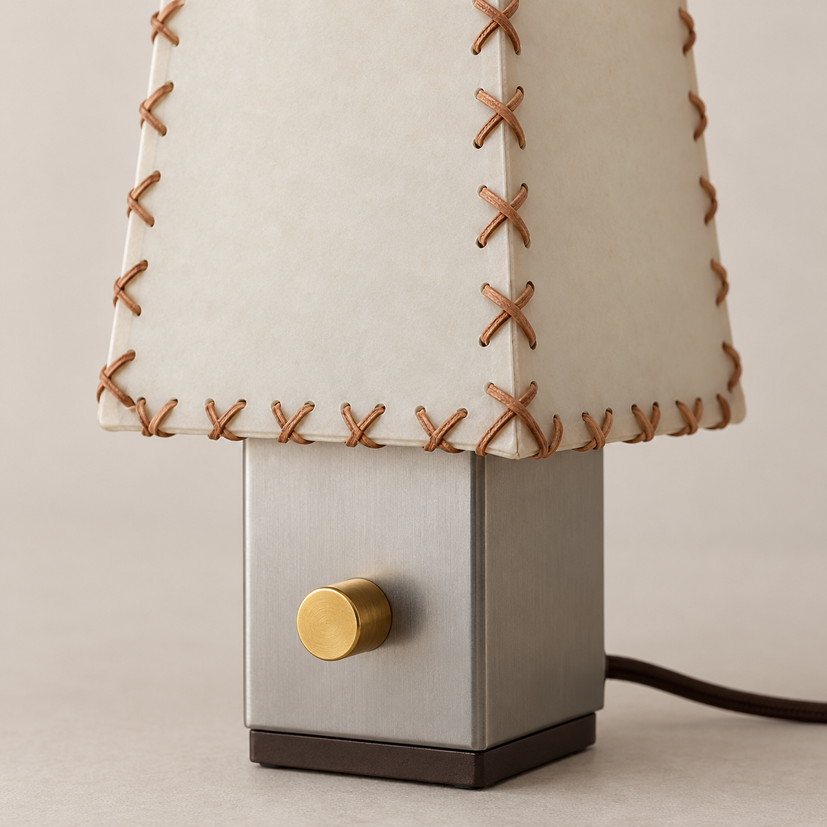 Detail of parchment stitching and the brass control knob.