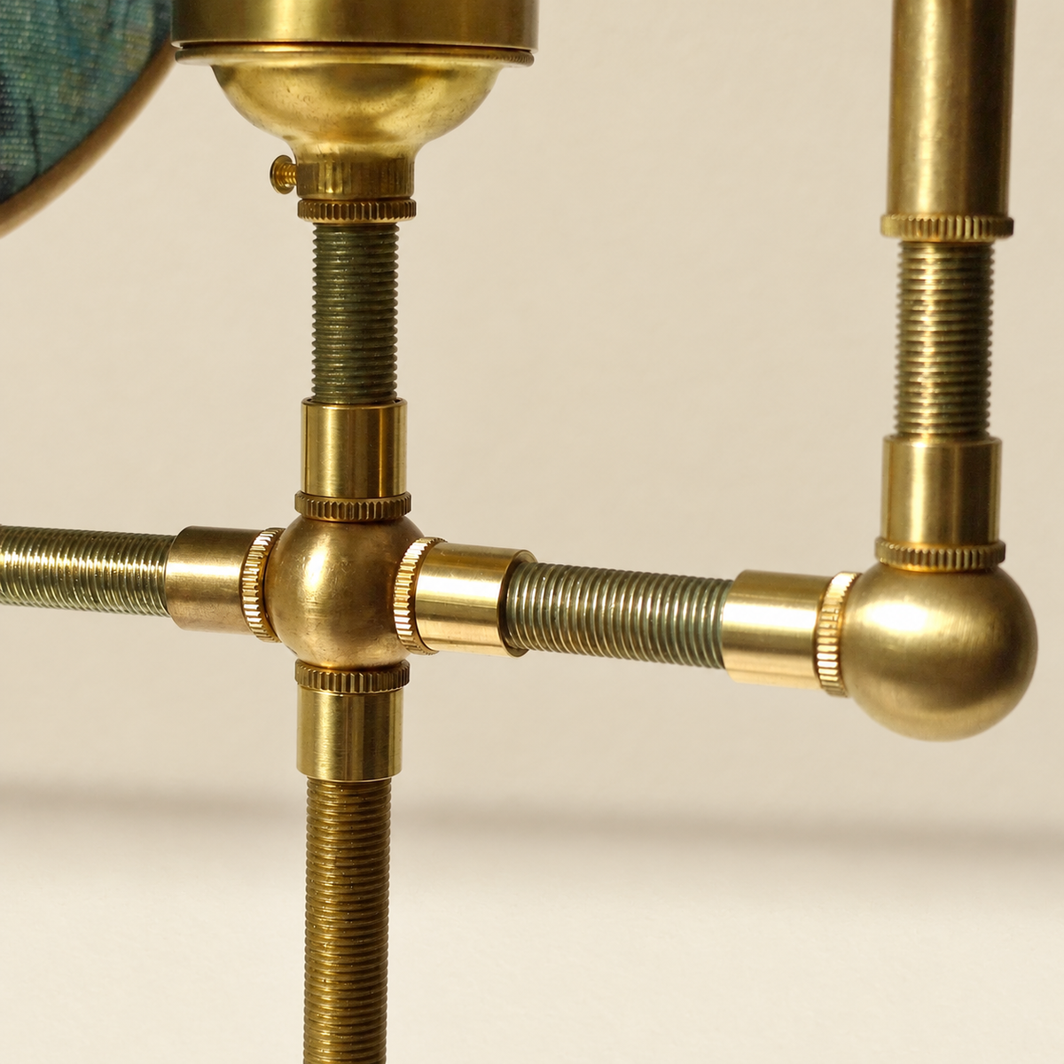 Close-up of Luce di Rame brass threaded joints and connecting rods.