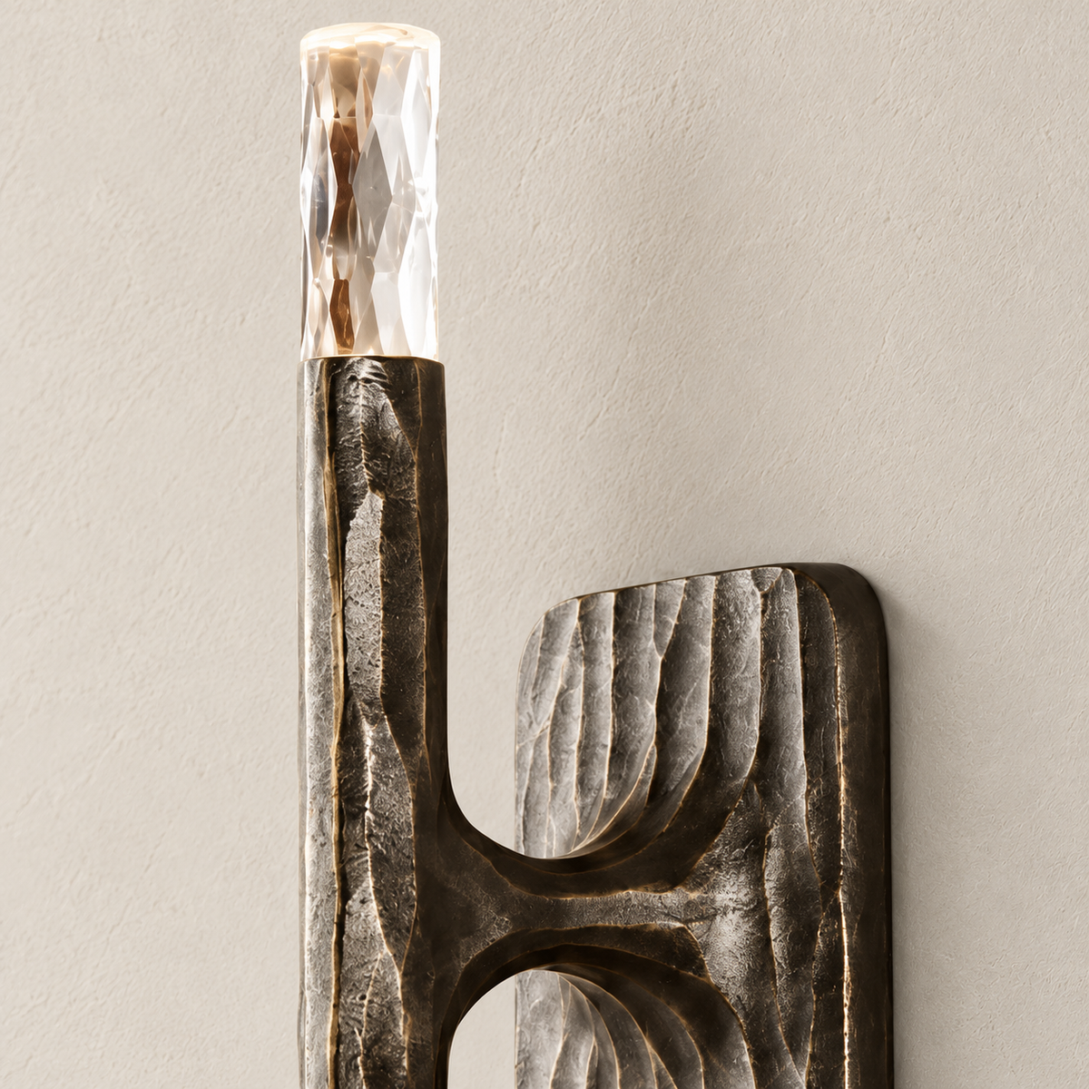 Sculptural stainless steel stick wall sconce showing its material and mounting detail.