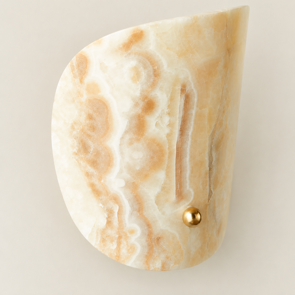 Close-up of the jade sconce's natural banding and polished brass ball fastener.