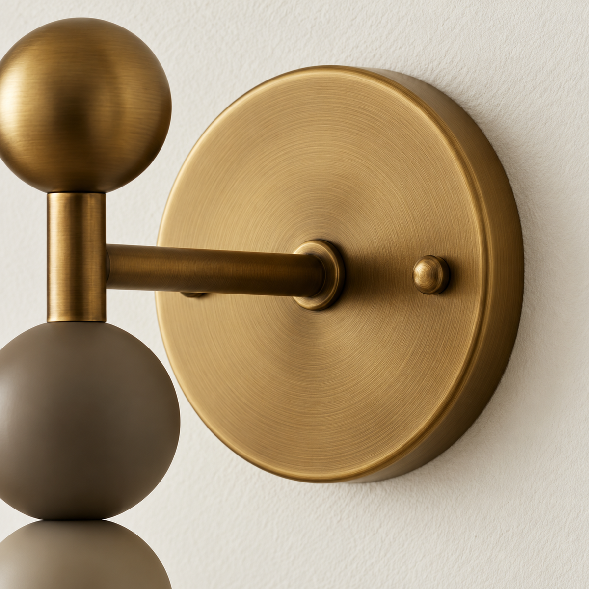 Detail of the CLSUPQ75 brushed brass backplate, fixing knob and projecting arm.