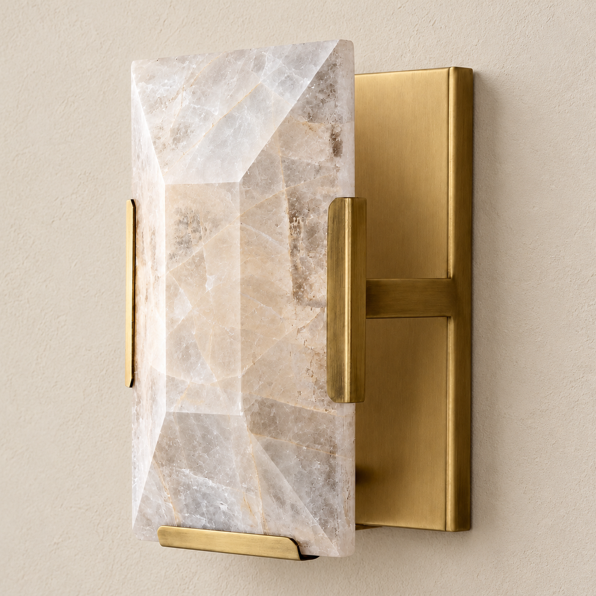 Calcite wall sconce with brass hardware, switched off on a beige wall.