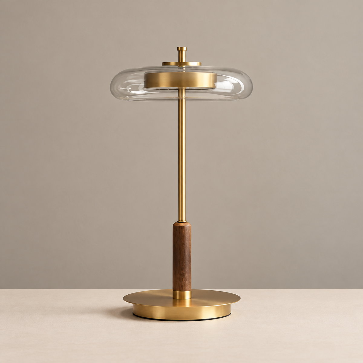 Clear halo glass table lamp with gold-tone stem and wood detail, unlit