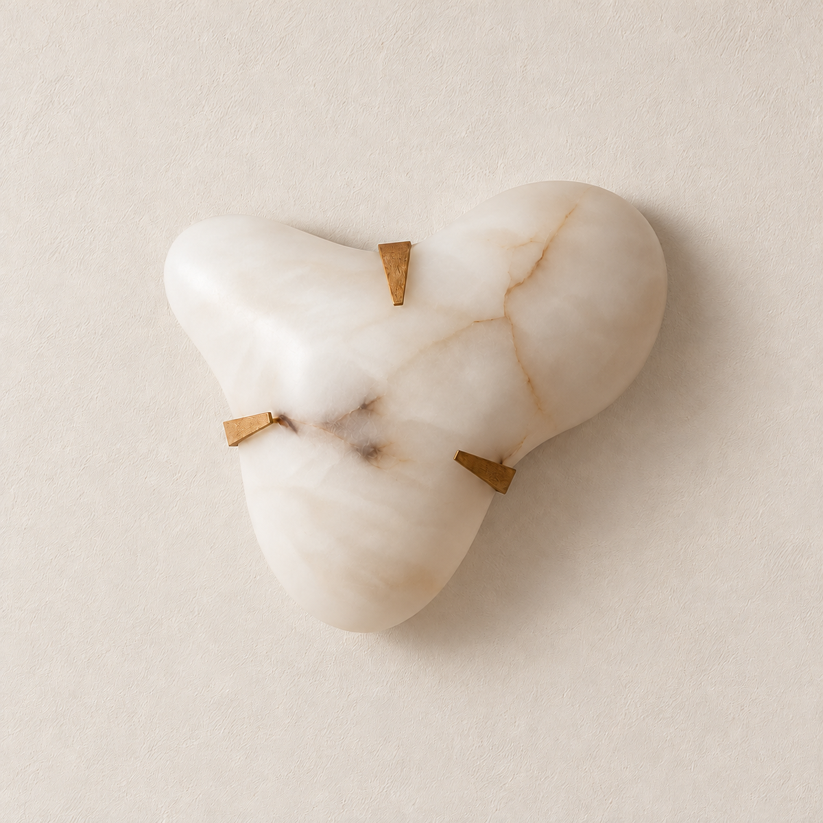 Three-lobed alabaster cloud wall sconce with three brass clips, light off on ivory.