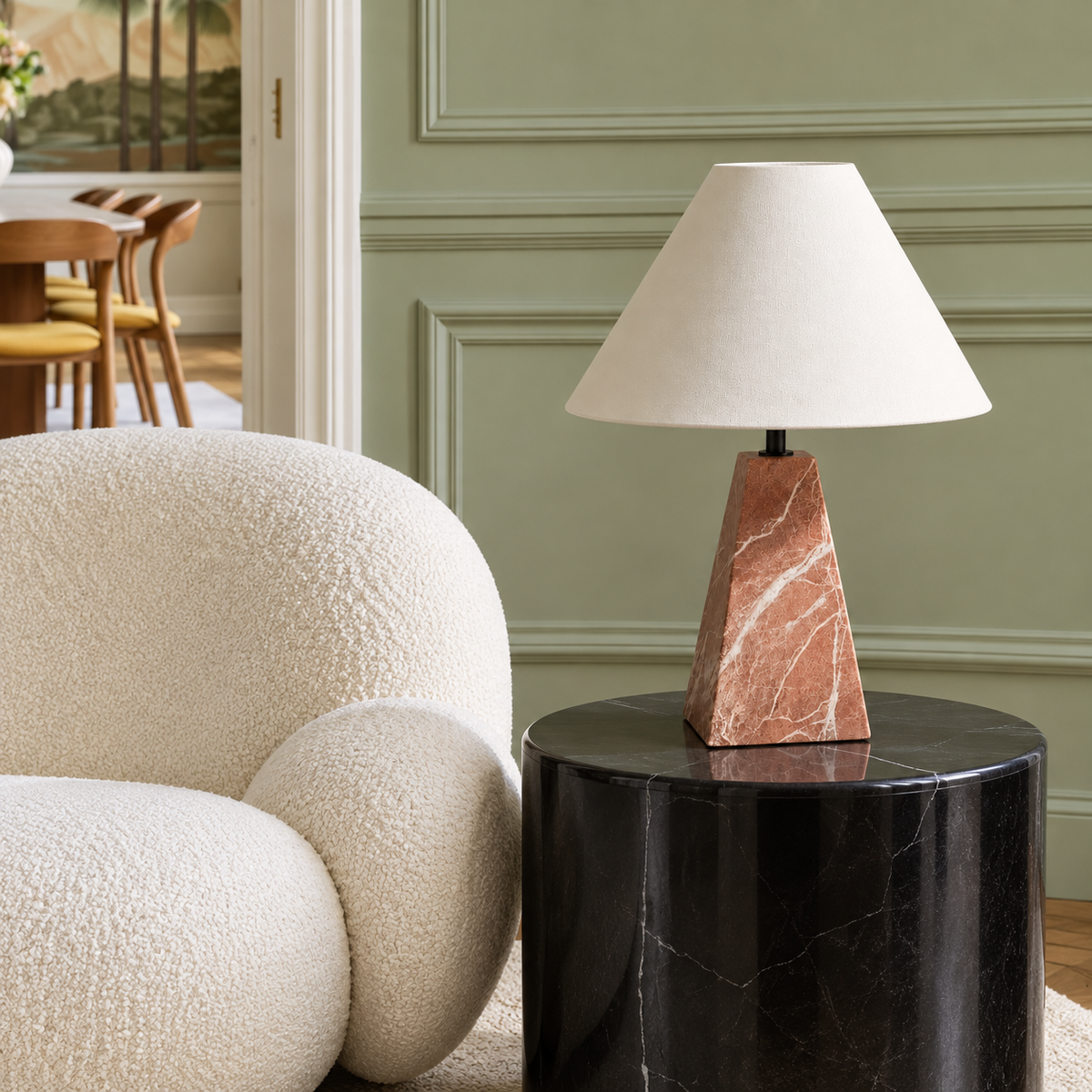Red marble table lamp with an ivory fabric shade, placed in a living room setting