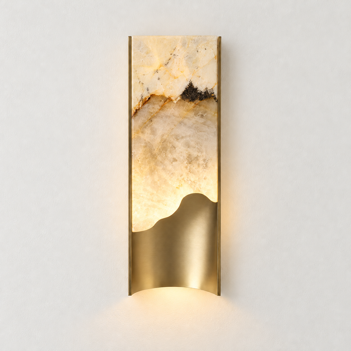 The same small onyx and brass wall sconce illuminated.