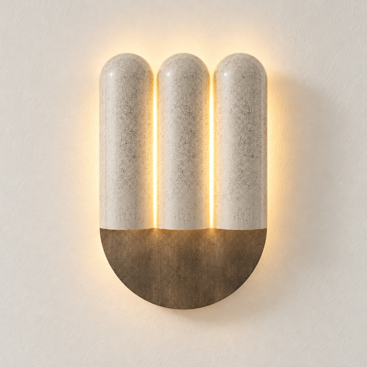 Triple crackle ceramic wall sconce mounted on ivory plaster, illuminated.