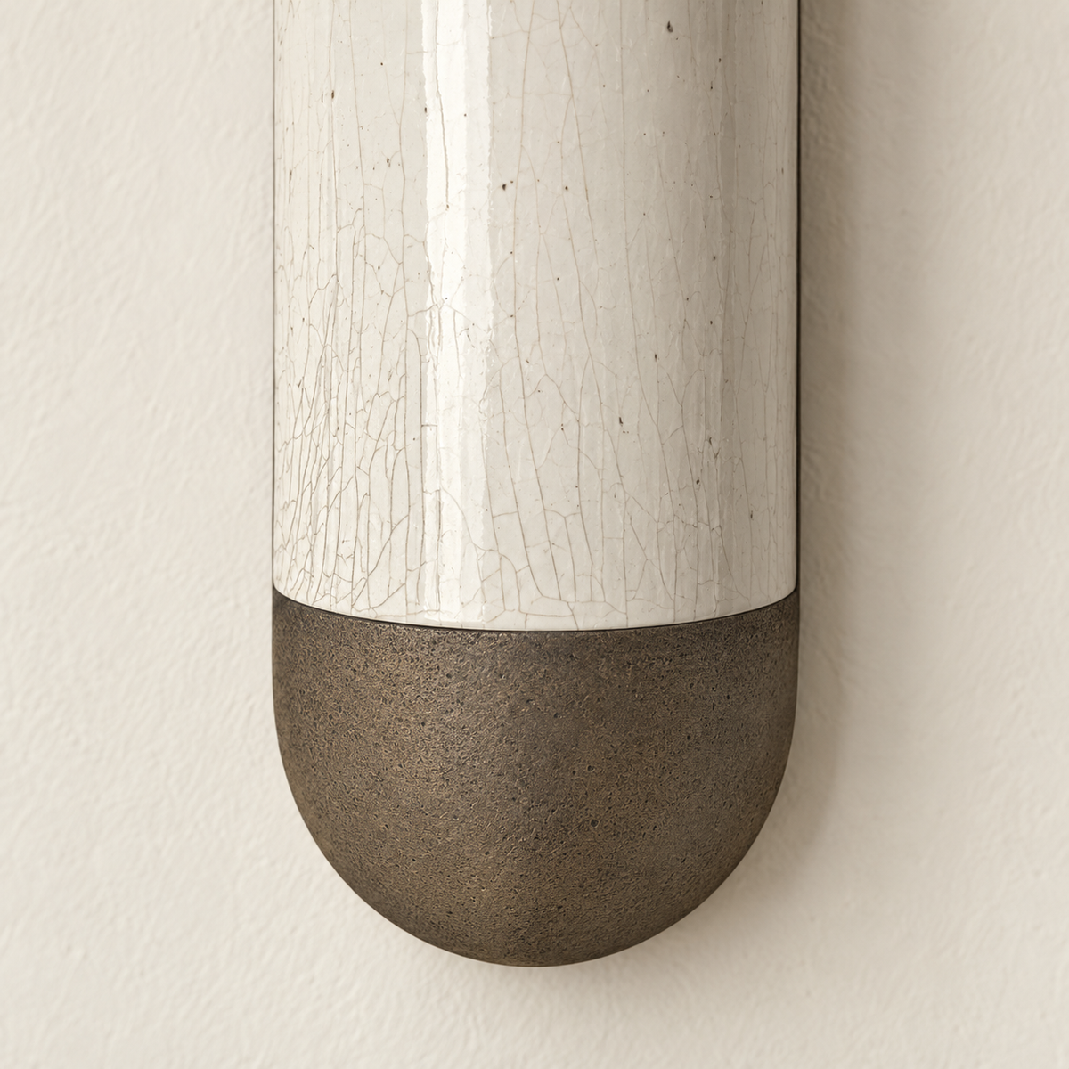 Close-up of the ceramic sconce’s fine crackle glaze and curved bronze base.