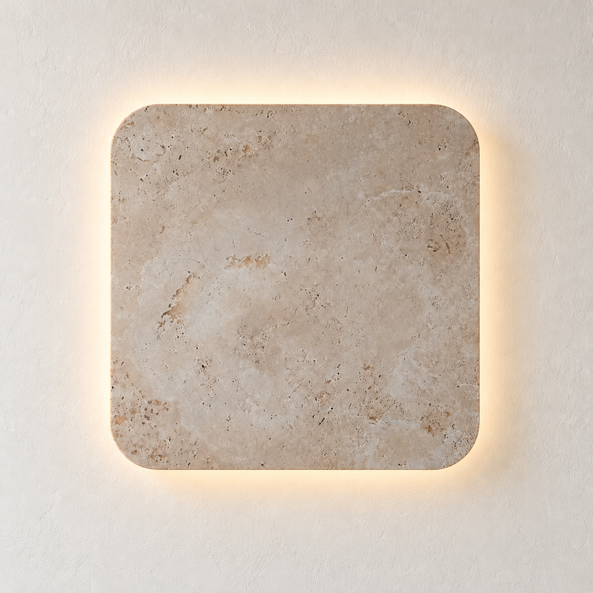 Square travertine wall light with rounded corners, illuminated on ivory plaster.