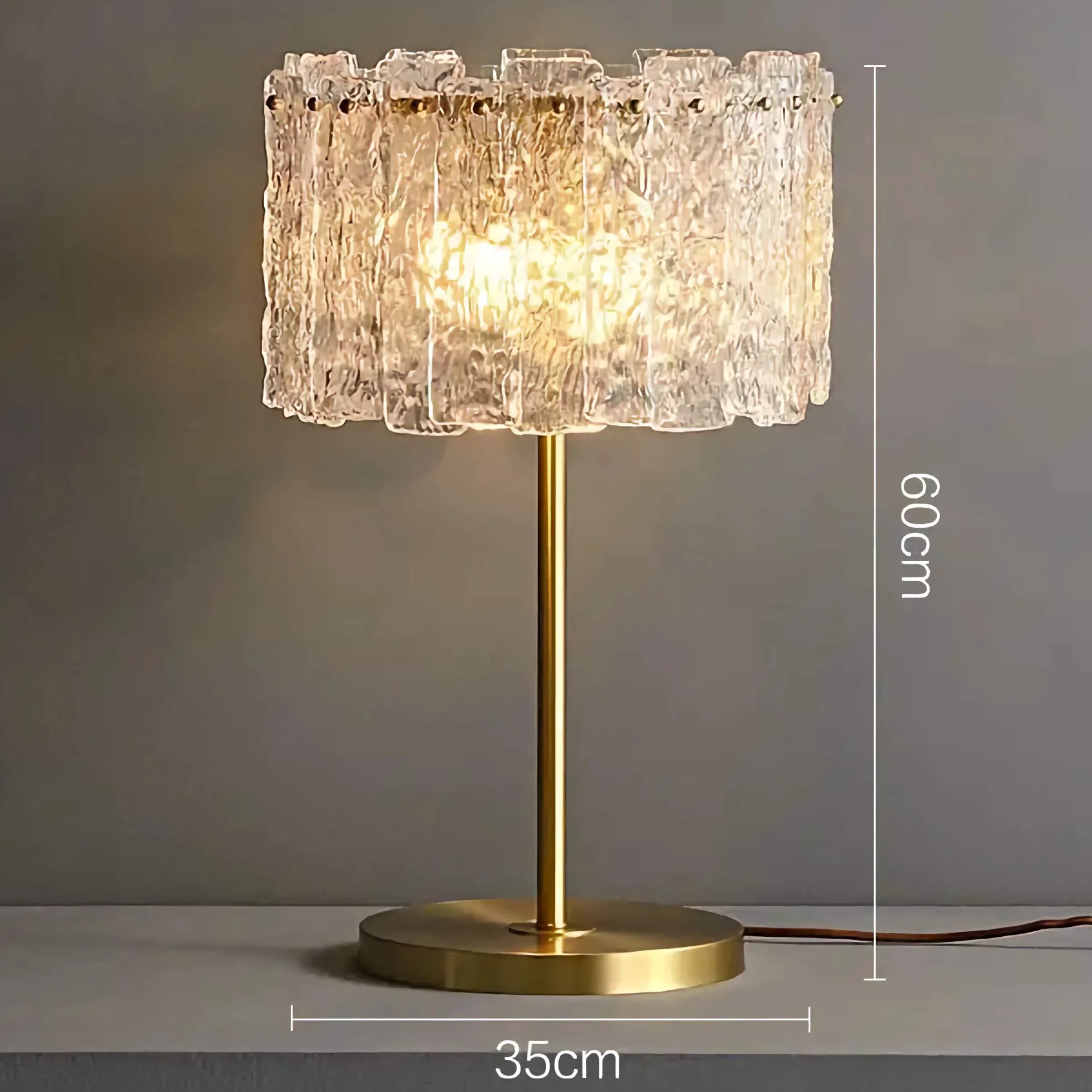 Glass and brass table lamp glowing warm