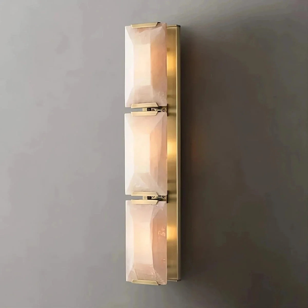 Gold triple calcite and copper wall sconce on a staircase