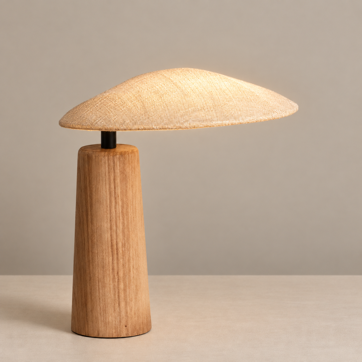 Kezawa Table Lamp, illuminated, on a neutral beige background.