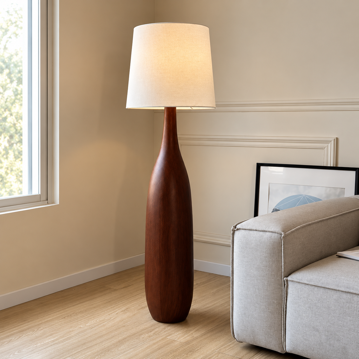La Quercia in Walnut beside a pale sofa and window in a moulded-wall room.
