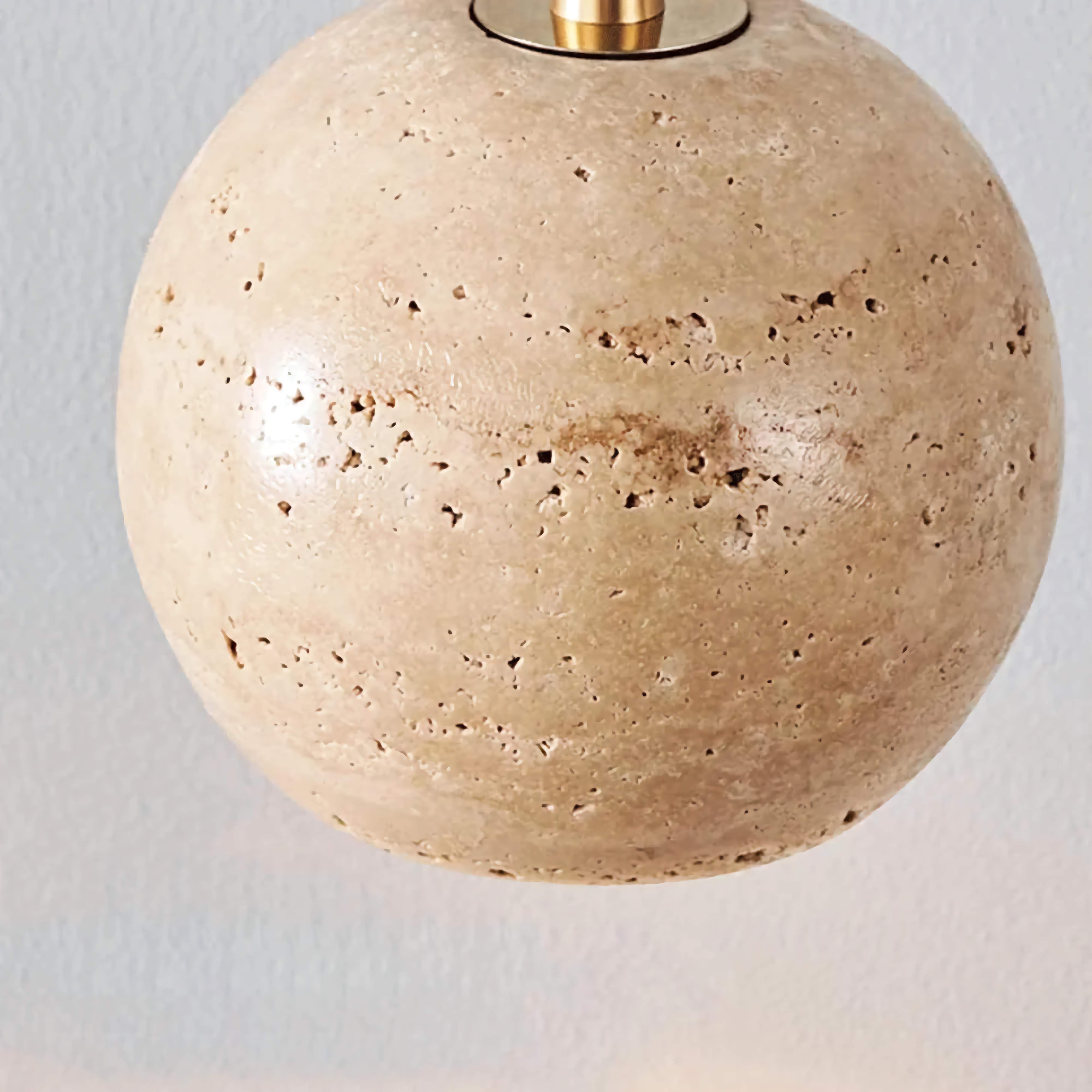 Cluster of travertine globe pendants in a stairwell