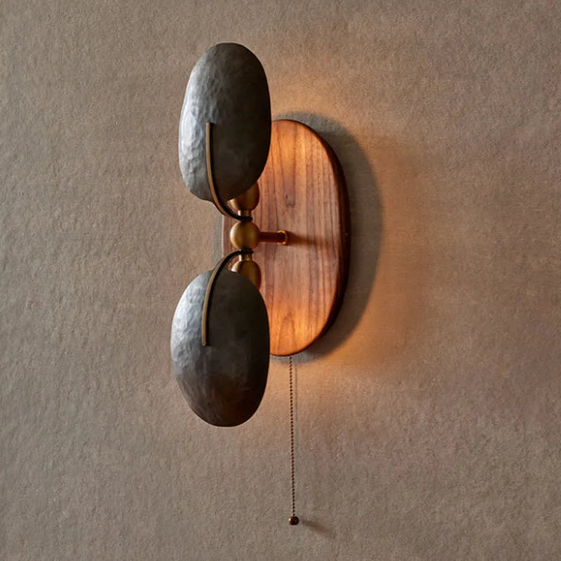 Iron and walnut sconce in a reading corner